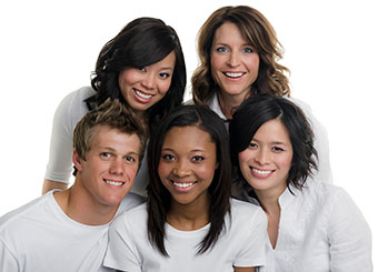 Group of 5 people in white smiling